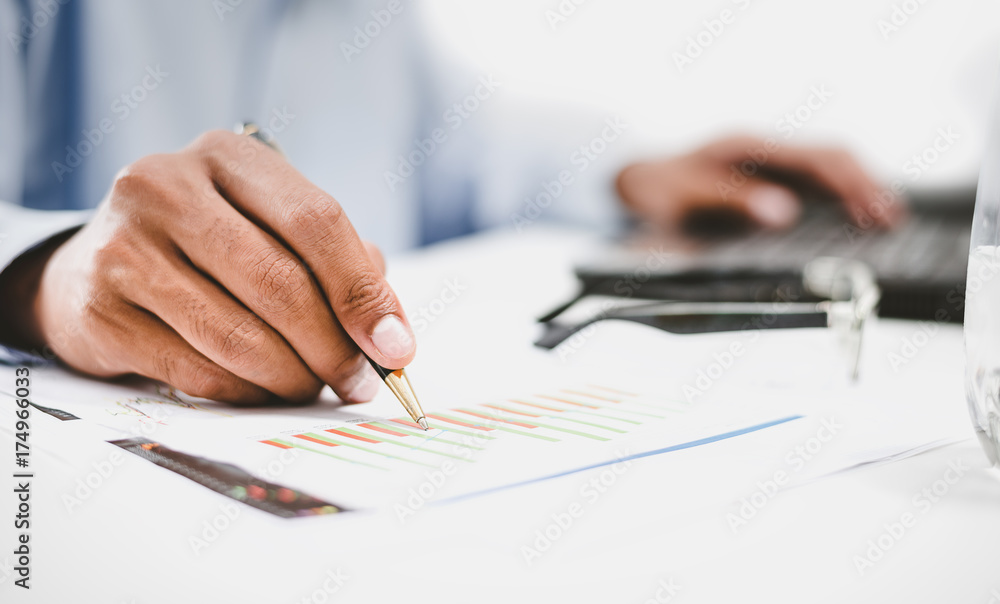 Businessmen are busy their work on paper and on the computer screen his. Businessmen are busy their work on paper and on the computer screen his.