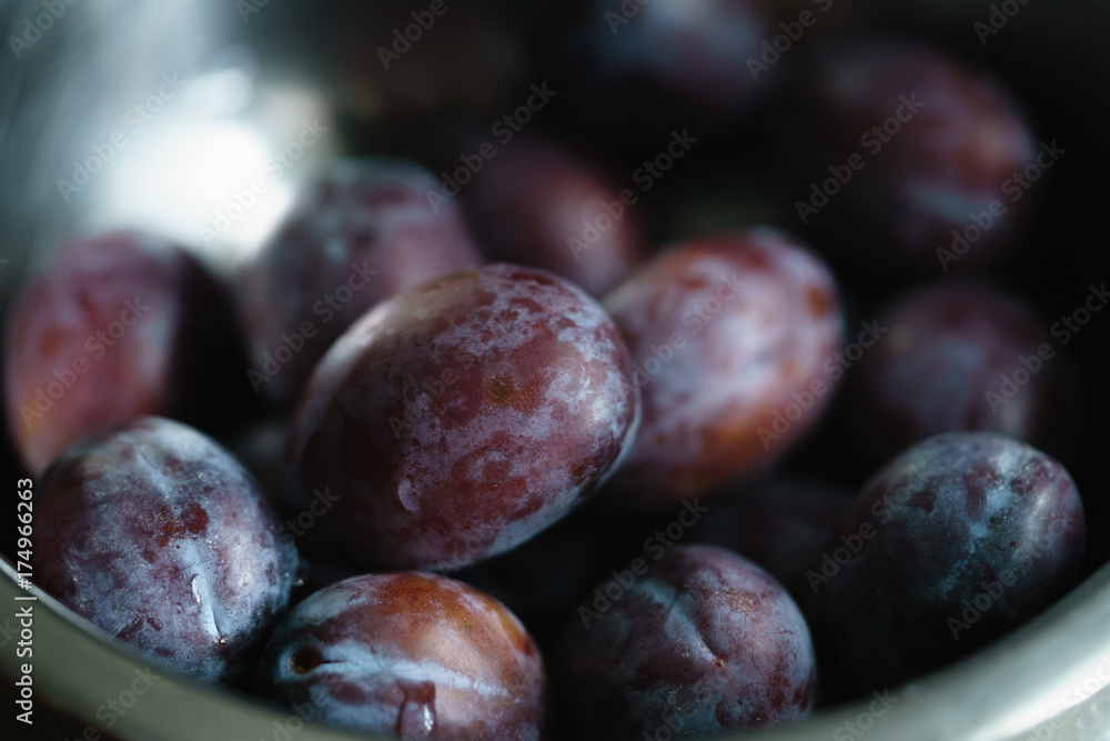 Fototapeta premium fresh plums in steel bowl closeup
