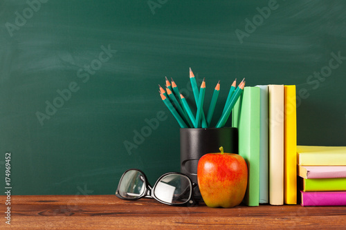 back to school - apple and books with pencils and blackboard