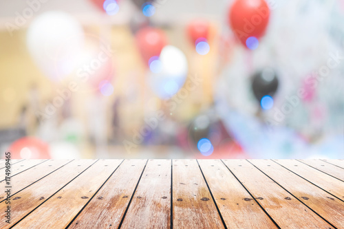 Empty wooden table with party in wedding background blurred.