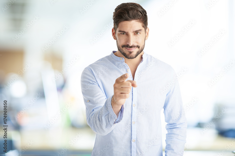Hey you. Young sales businessman looking at you and pointing at the camera Hey you. Young sales businessman looking at you and pointing at the camera