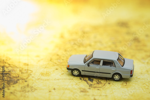 Transportation and travel concept. Mini car toy on world map.