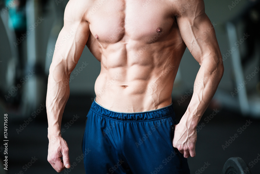 Fitness concept. Muscular and sexy torso of young man having perfect abs, bicep and chest. Male hunk with athletic body. Fitness concept. Muscular and sexy torso of young man having perfect abs, bicep and chest. Male hunk with athletic body.