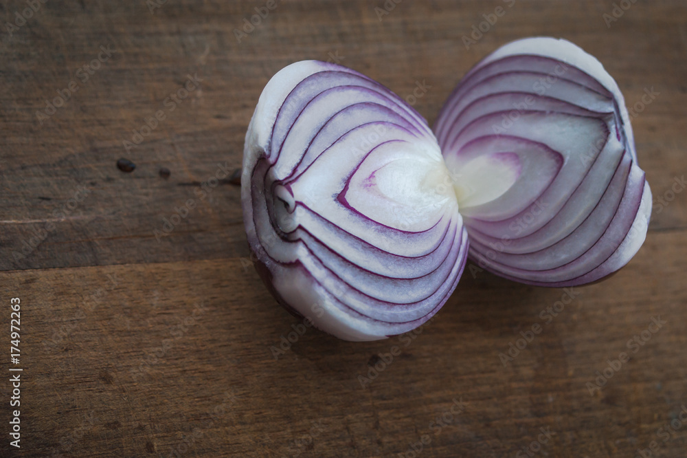 Food preparation, cooking concept: chopped and peeled fresh red onions on rustic wooden background Food preparation, cooking concept: chopped and peeled fresh red onions on rustic wooden background