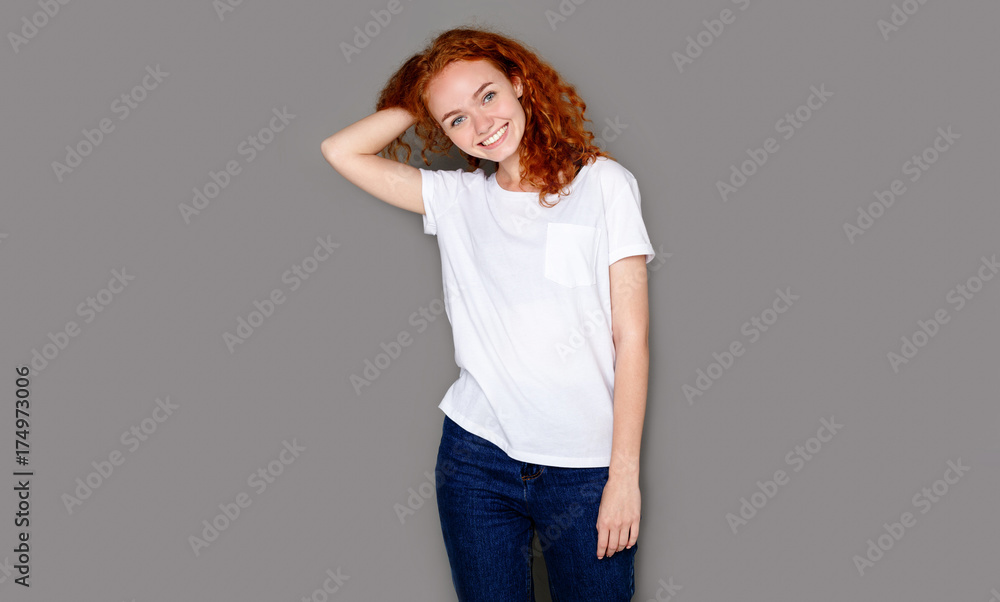 Cheerful girl in casual clothes posing at studio Cheerful girl in casual clothes posing at studio