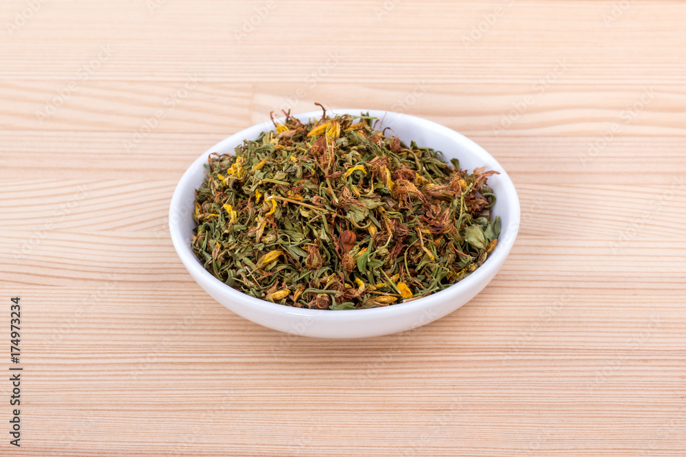 dried St. John's wort / Bowl of dried St. John's wort dried St. John's wort / Bowl of dried St. John's wort