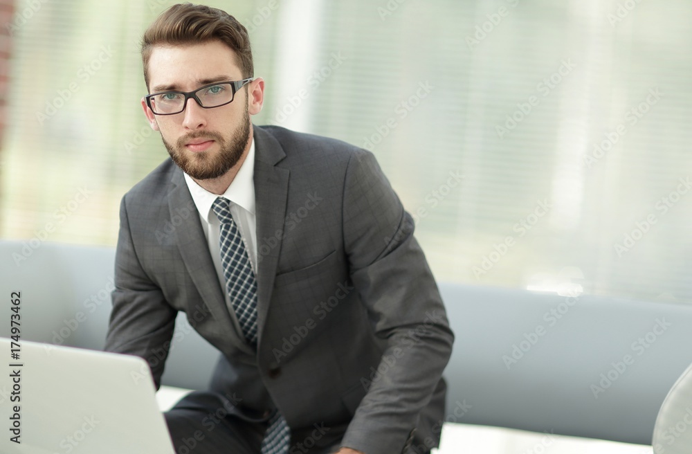 Portrait of a modern businessman sitting at his desk. Portrait of a modern businessman sitting at his desk.