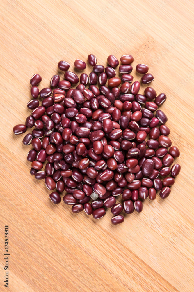 Red adzuki beans on a wood background Red adzuki beans on a wood background