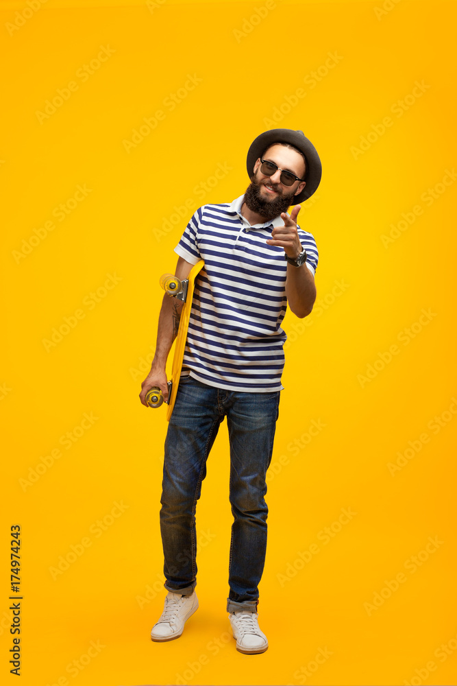 Man with longboard pointing at camera Man with longboard pointing at camera