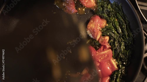 overhead shot sauteing spinach and tomatoes 4k