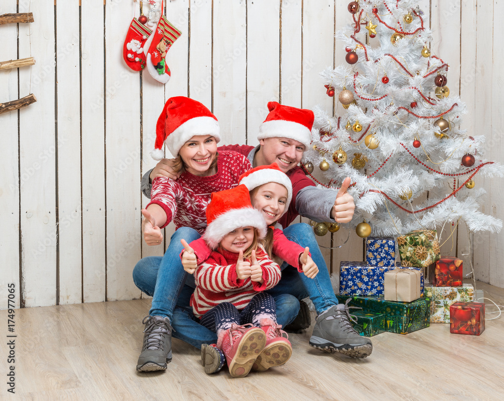 big family in red santa hats near the christmas tree big family in red santa hats near the christmas tree