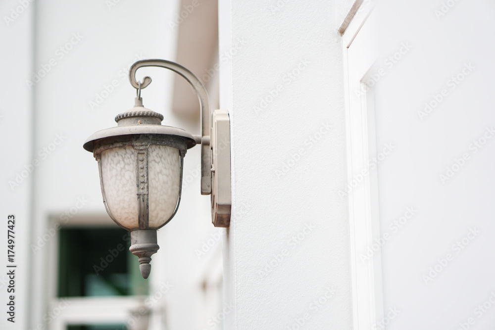 old outdoor wall lamp light on white exterior