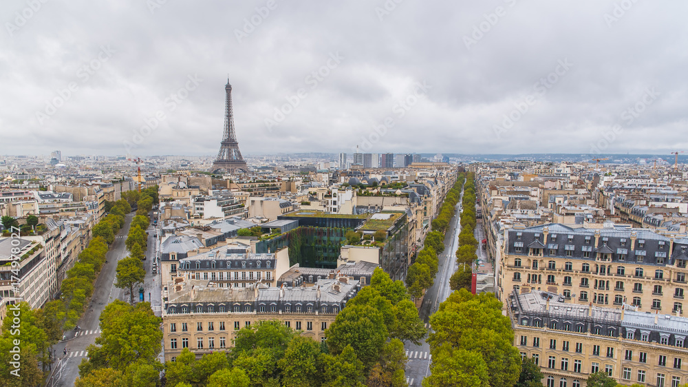 Paris, panorama from Arc de Triomphe, buildings, avenues and the Eiffel tower in background
