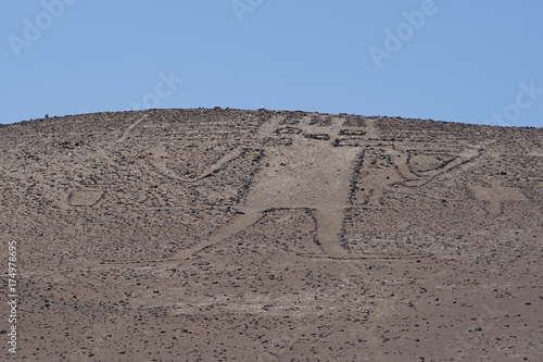 Giant of the Atacama. Large petroglyph on a rocky outcrop in the Atacama Desert in the Tarapaca Region of northern Chile. 