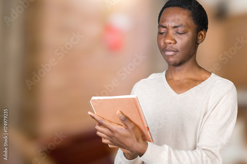 Young African American Male Holding Notepad