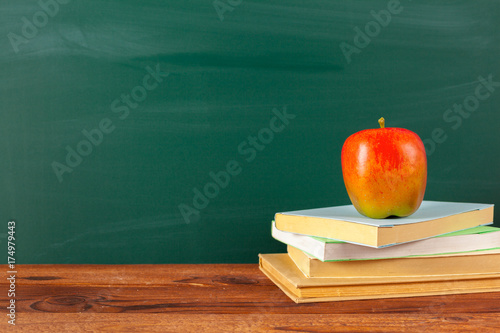 back to school - apple and books with pencils and blackboard