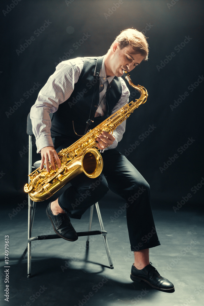 Naklejka premium Young man playing the Saxophone