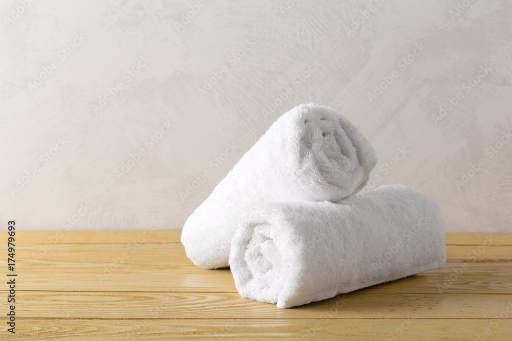 spa towels on wooden surface spa towels on wooden surface