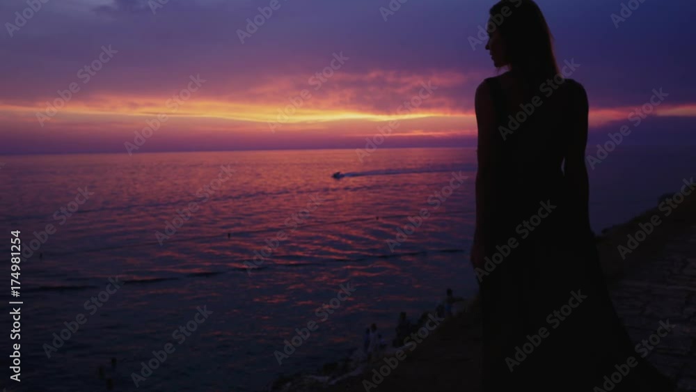 Woman enjoying a sunset in a Rovinj, Croatia Woman enjoying a sunset in a Rovinj, Croatia