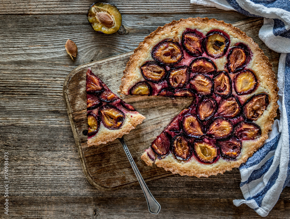 Homemade plum pie on the wooden background Homemade plum pie on the wooden background