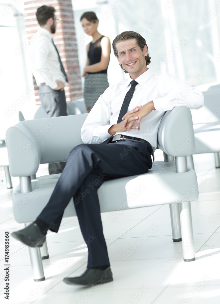 smiling businessman sitting in office chair smiling businessman sitting in office chair