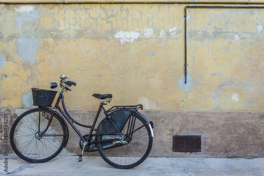 Retro bicycle with basket in front of the old wall, background Retro bicycle with basket in front of the old wall, background