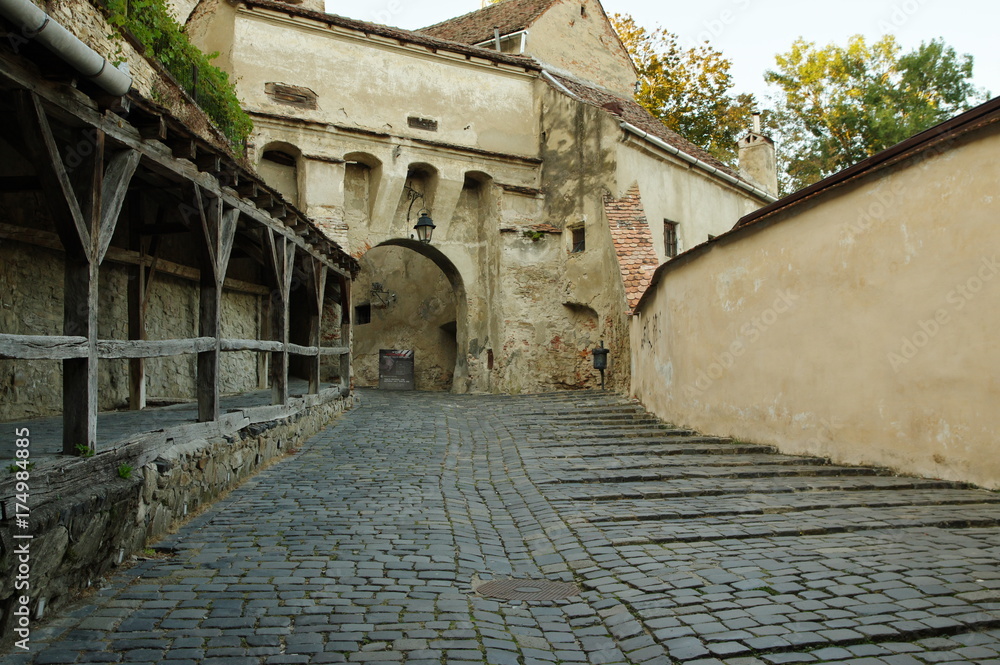 Sighisoara, medieval fortified town in Transylvania. Defensive walls and gate leading to medieval old town. Sighisoara, medieval fortified town in Transylvania. Defensive walls and gate leading to medieval old town.