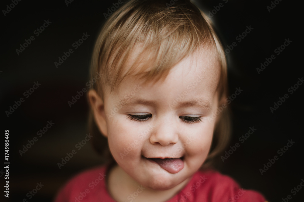 Portrait of toddler sticking her tongue out 