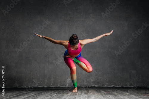 Young beautiful yoga female posing in studio