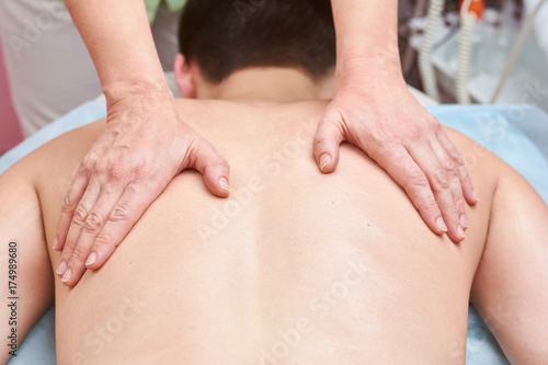 Hands massaging back close up. Person having massage.