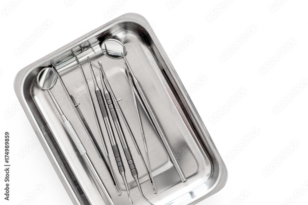 Basic dentists tools in cuvette on white background top view copyspace Basic dentists tools in cuvette on white background top view copyspace