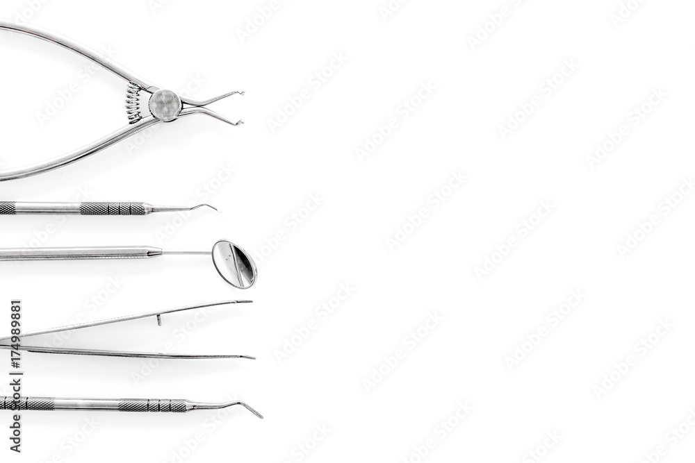 Set of dentists tools including round mirror on white background top view copyspace Set of dentists tools including round mirror on white background top view copyspace