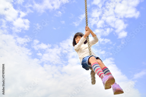 公園の遊具で楽しく遊ぶ女の子