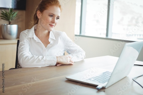 Thoughtful businesswoman sitting at desk