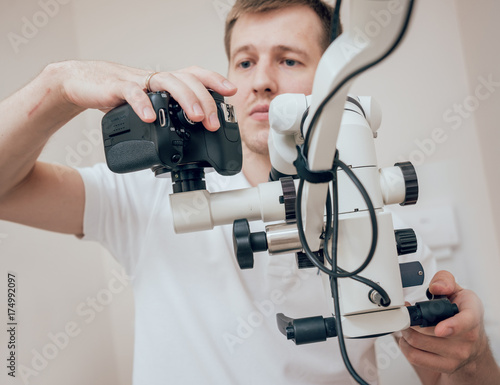 Microscope with photo camera in the dental office