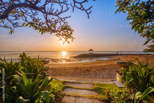 Beautiful sunrise on a beach in Bali Indonesia with colourful sky as background photo