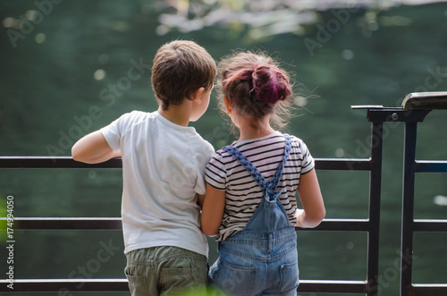 boy  and girl looking at green water