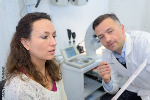 doctor with female patient reading notes