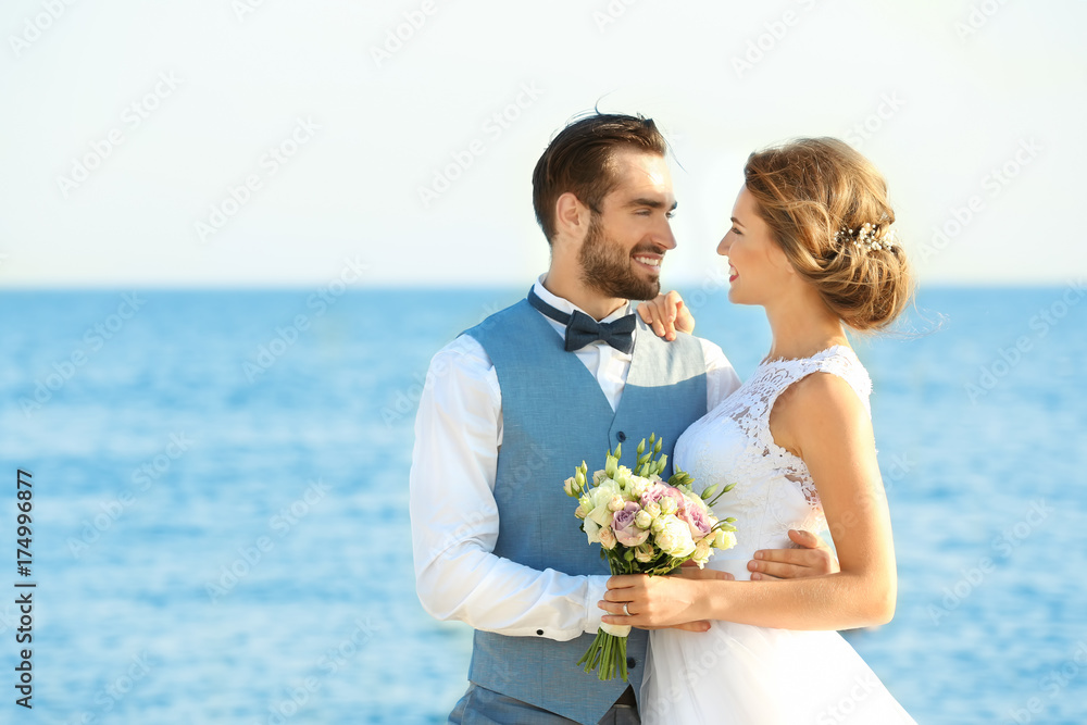 Happy wedding couple on sea beach Happy wedding couple on sea beach