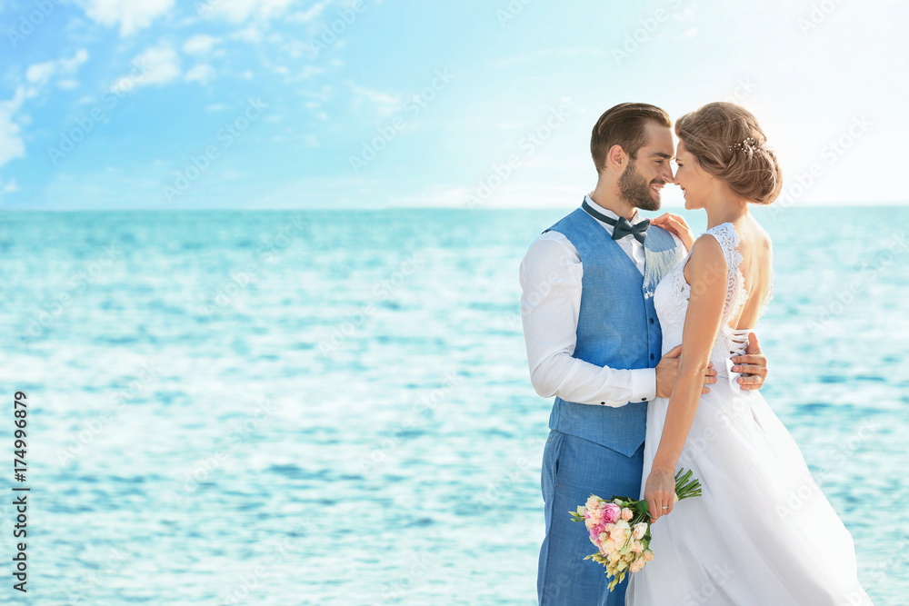 Happy wedding couple on sea beach