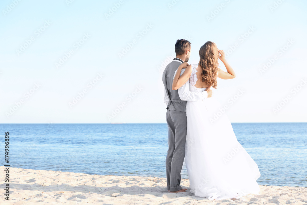 Happy wedding couple on sea beach Happy wedding couple on sea beach