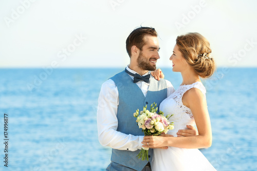 Happy wedding couple on sea...