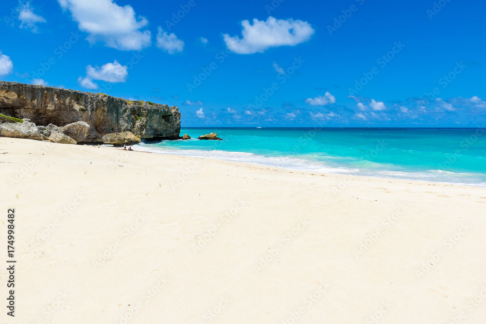 Bottom Bay, Barbados - Paradise beach on the Caribbean island of Barbados. Tropical coast with palms hanging over turquoise sea. Panoramic photo of beautiful landscape. Bottom Bay, Barbados - Paradise beach on the Caribbean island of Barbados. Tropical coast with palms hanging over turquoise sea. Panoramic photo of beautiful landscape.