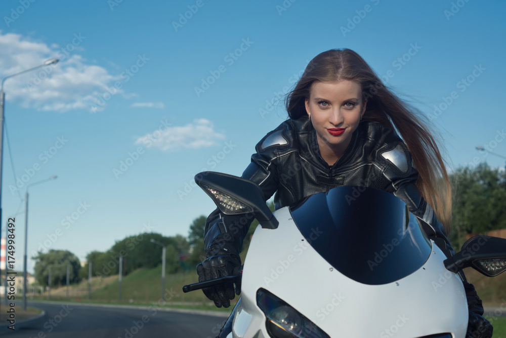 Naklejka premium Sexy biker girl in a leather jacket