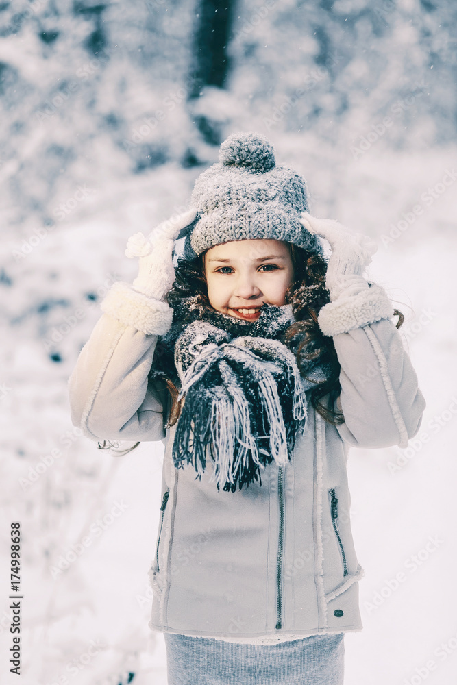 Winter outdoor close up portrait of adorable smiling little girl in knitted hat. Winter outdoor close up portrait of adorable smiling little girl in knitted hat.