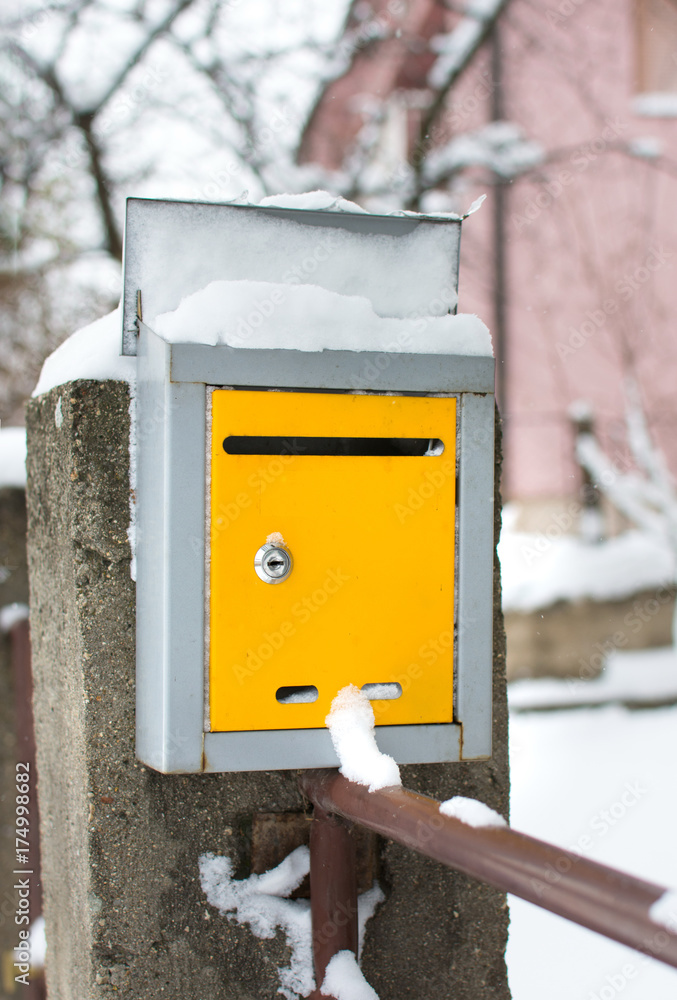 Snow covered mailbox in front of a house Snow covered mailbox in front of a house