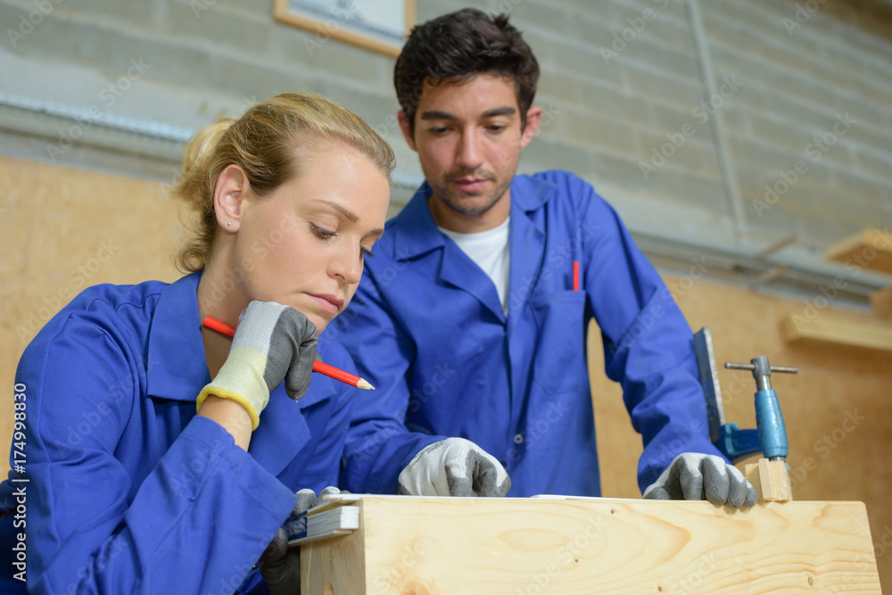 Young man and woman working with wood Young man and woman working with wood