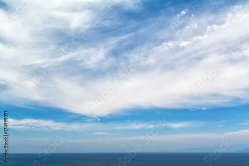 blue sea horizon and white clouds backround