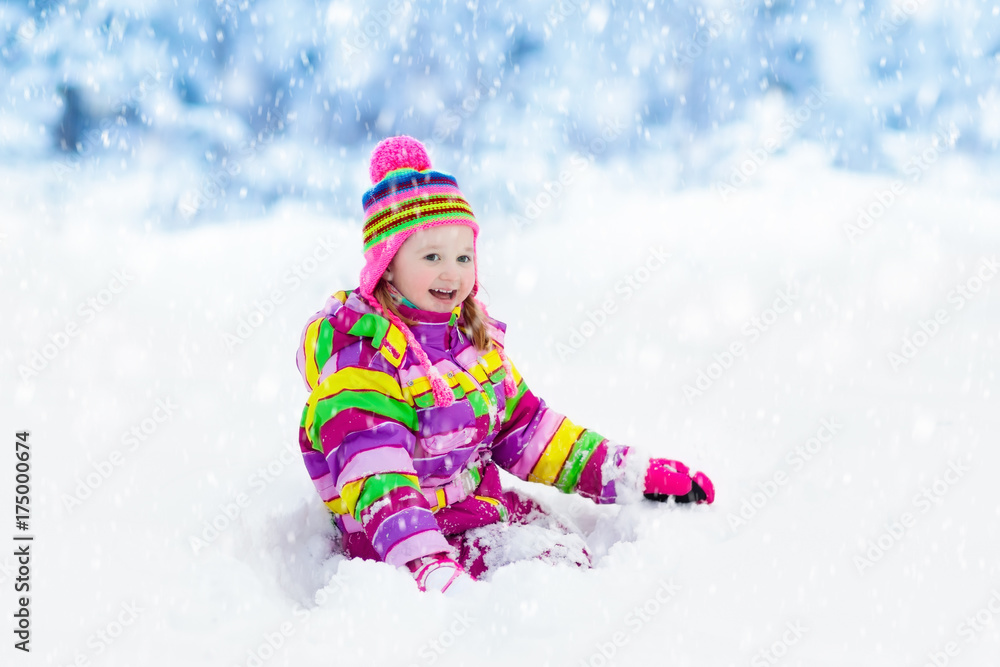 Child playing with snow in winter. Kids outdoors. Child playing with snow in winter. Kids outdoors.
