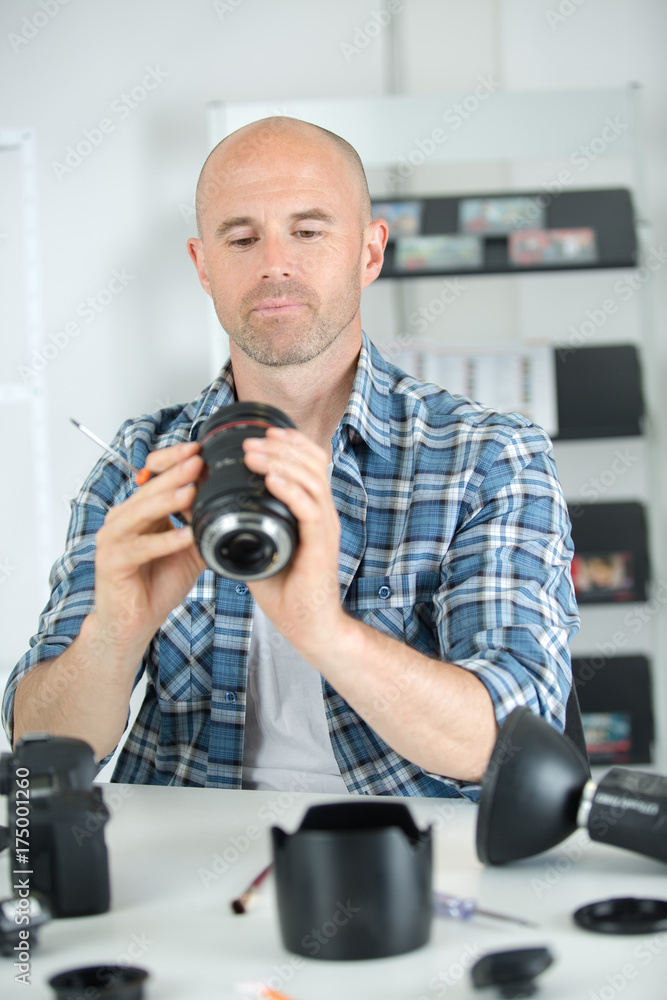 man holding a camera lens man holding a camera lens